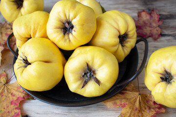 fresh yellow quince on a wooden table