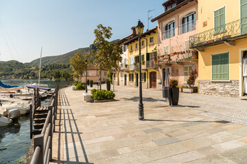 Fototapeta premium Lakeside promenade in ancient village Pella on the shore of Lake Orta, province of Novara, Piedmont, Italy