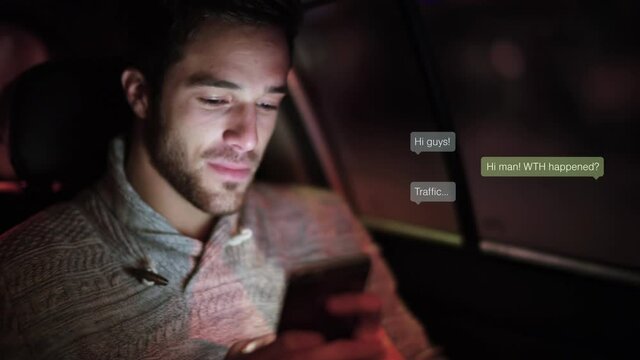 Casual young man using smartphone in car at night. He is chatting with friends. Animations with texts appearing. Messaging app.