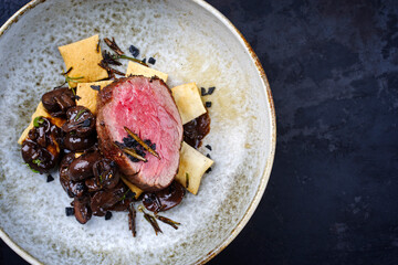 Modern style traditional fried dry aged angus beef filet medaillons natural with mushrooms and...