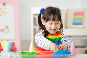 young girl playing color sorting and fine motor skill for homeschooling