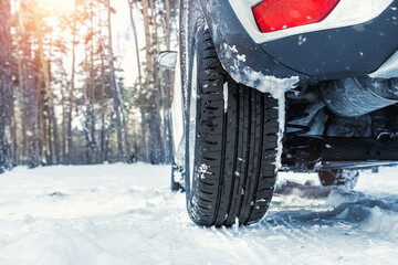Close-up detail view of car wheel with unsafe summer tread tire during driving through slippery snow road at winter season. Danger traffic accident collision risk. Seasonal tyre switch concept © Kyryl Gorlov