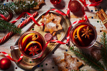 Mulled wine with Christmas decor on rustic wooden table