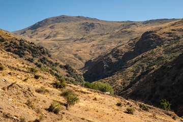 Scenic view of the Poqueira valley with the summit of Mount Mulhacén in the distance, seen from a hiking trail near Capileira, Las Alpujarras, Sierra Nevada National Park, Andalusia, Spain