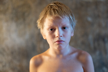 Confused blond boy woke up in morning not at home
