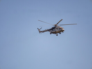 Fototapeta na wymiar Military helicopter flies high in sky