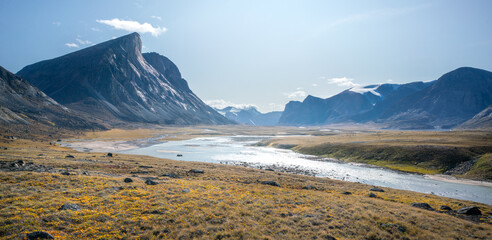 Wild Owl River winds through remote arctic landscape in Akshayuk Pass, Baffin Island, Canada. Moss...