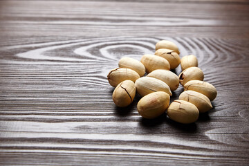 Pecan nuts into shell on wooden table
