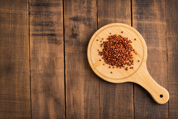 Chenopodium quinoa - Red organic quinoa seeds on the wooden board
