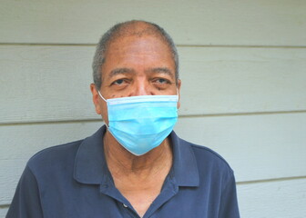 Man wearing a face mask to combat the covid--19 virus.