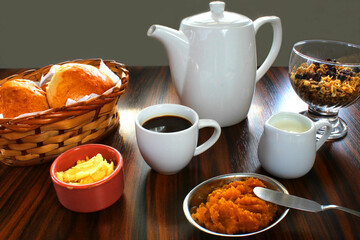 Breakfast in Brazil. Typical Brazilian breakfast foods, coffee and milk, homemade bread, butter, jam and cereal granola