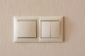 beige switches on the wall. the concept of renovation in the apartment