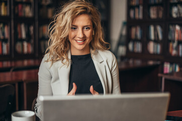 Woman using airpods and a laptop for an conference call