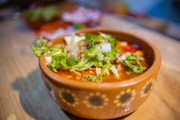 Clay bowl of delicious and traditional Mexican pozole