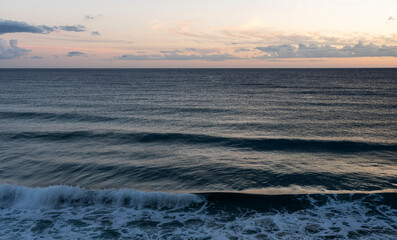 The calm sea at sunset.