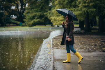 Woman holding an umbrella while walking in the park
