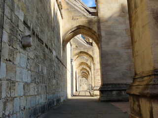 Nice walkway under flying buttresses of Winchester cathedral, England, UK