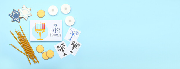 Different symbols of Hanukkah and greeting card on color background with space for text