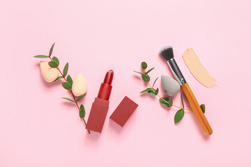 Stylish makeup sponges, lipstick and brush on color background