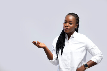 woman raising hands emotionless standing over grey white background. Looking at camera.