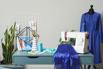 Tailor's workplace with sewing machine in stylish atelier