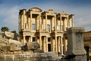  The ruined facade of the magnificent Library of Celsus stands amid tumbled Roman columns and blocks, Ephesus, Turkey