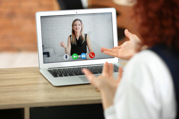 Fototapeta na wymiar Young woman video chatting with HR manager at home