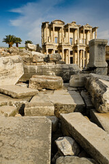  The ruined facade of the magnificent Library of Celsus stands amid tumbled Roman columns and blocks, Ephesus, Turkey