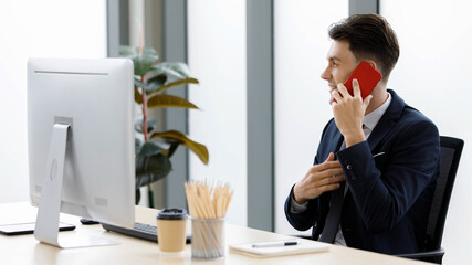 Millennial Caucasian happy male businessman officer staff in formal business suit sitting smiling...