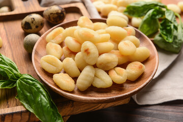 Plate with tasty gnocchi on table