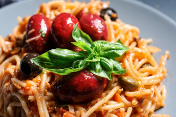 Delicious Pasta Puttanesca on plate, closeup