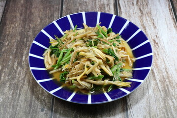 Traditional fried dried daylily with Chinese celery serving on the plate. Classic vegetarian menu in Asia restaurant. 