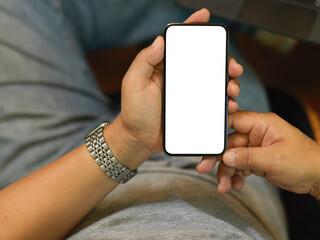 Cropped shot of Aged business man using smartphone, blank screen mockup