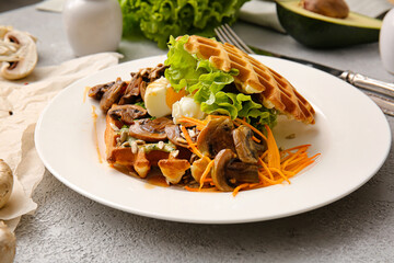 Delicious Belgian waffles with vegetables in plate on light background, closeup