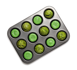 Baking tin with tasty spinach muffins on white background