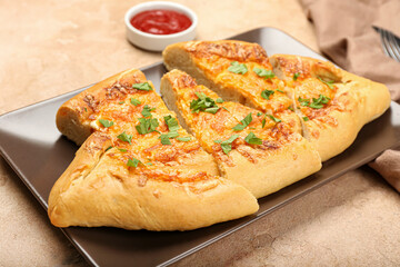 Plate with sliced Turkish Pizza on beige background