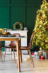 Interior of living room with table setting for Christmas dinner
