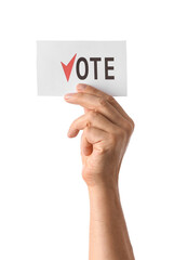 Hand holding paper with text VOTE on white background