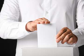 Voting man near ballot box, closeup