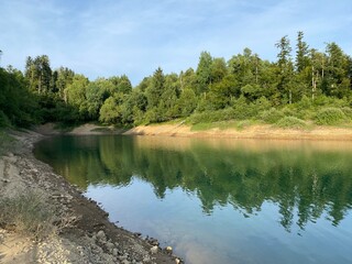 Obraz premium Artificial reservoir Lake Lokve or Artificial accumulation Lokvarsko Lake - Gorski kotar, Croatia (Lokvarsko jezero ili umjetno akumulacijsko Omladinsko jezero, Lokve - Gorski kotar, Hrvatska)