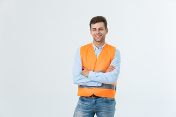 Happy engineer smiling and standing confidently, guy wearing caro shirt and jeans with orange vest,...