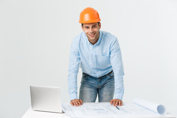 Happy young construction workers in hard hats on a white background.