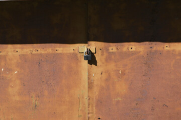 Old red metal door with padlocks
