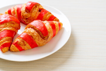 fresh croissant with strawberry jam sauce