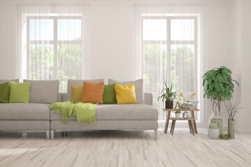 White living room with sofa and summer landscape in window. Scandinavian interior design. 3D illustration