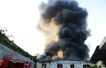 Fire burning and black smoke over the factory