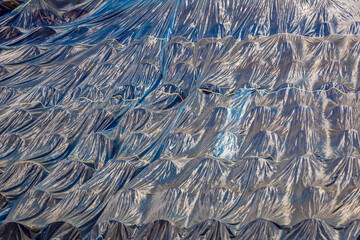 Theater chairs covered with construction film in the auditorium.