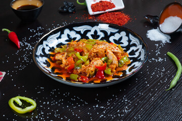 Eastern cuisine. Fried chicken with bell pepper and spices on plate