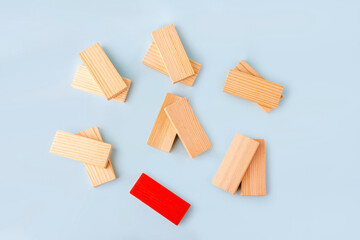 Wooden blocks in pairs and one red as symbol of love couple and single, bachelor. Diversity and ndividuality and uniqueness. Concept of exclusion, loneliness, difference, discrimination.