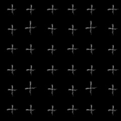 White chalk crosses on a black background